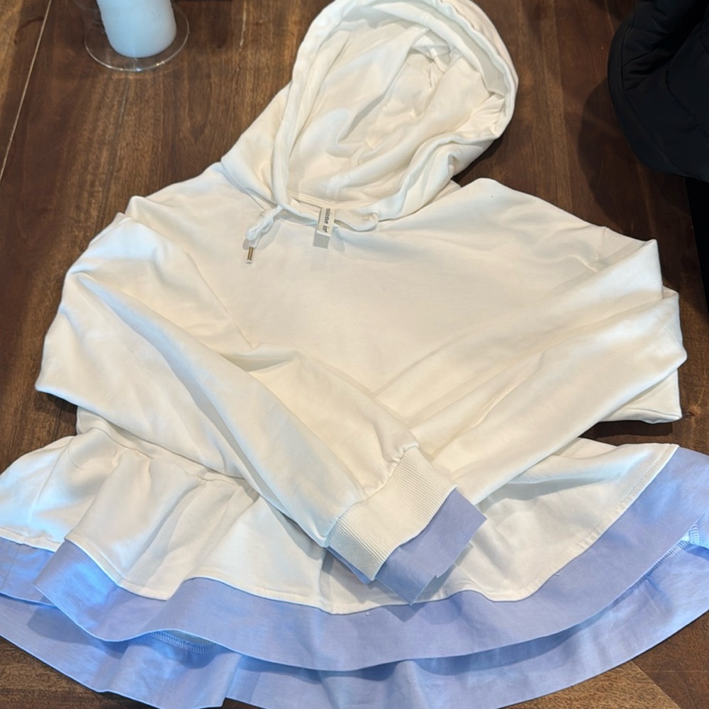 White short hoodie with an Oxford blue ruffle on the bottom. Size OS